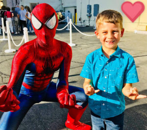spiderman party character for a birthday party standing with birthday boy